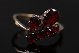 Golden ring with different shaped red garnets
