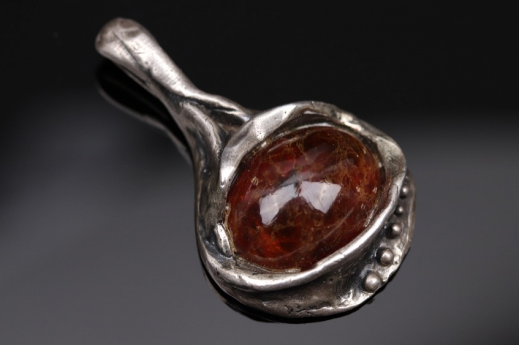 Silver pendant with amber cabochon