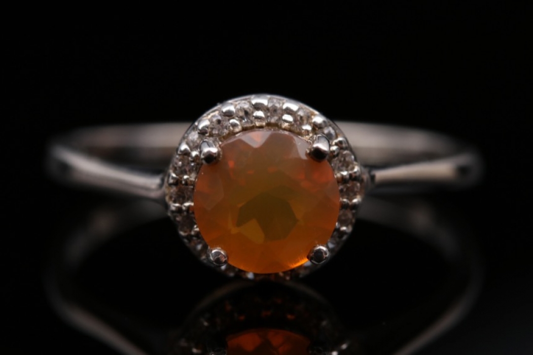 Silver ring with orange 'Buriti' opal and small white gemstones