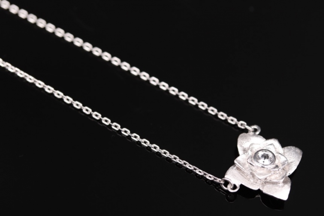 Silver necklace with rose-shaped pendant and white topaz
