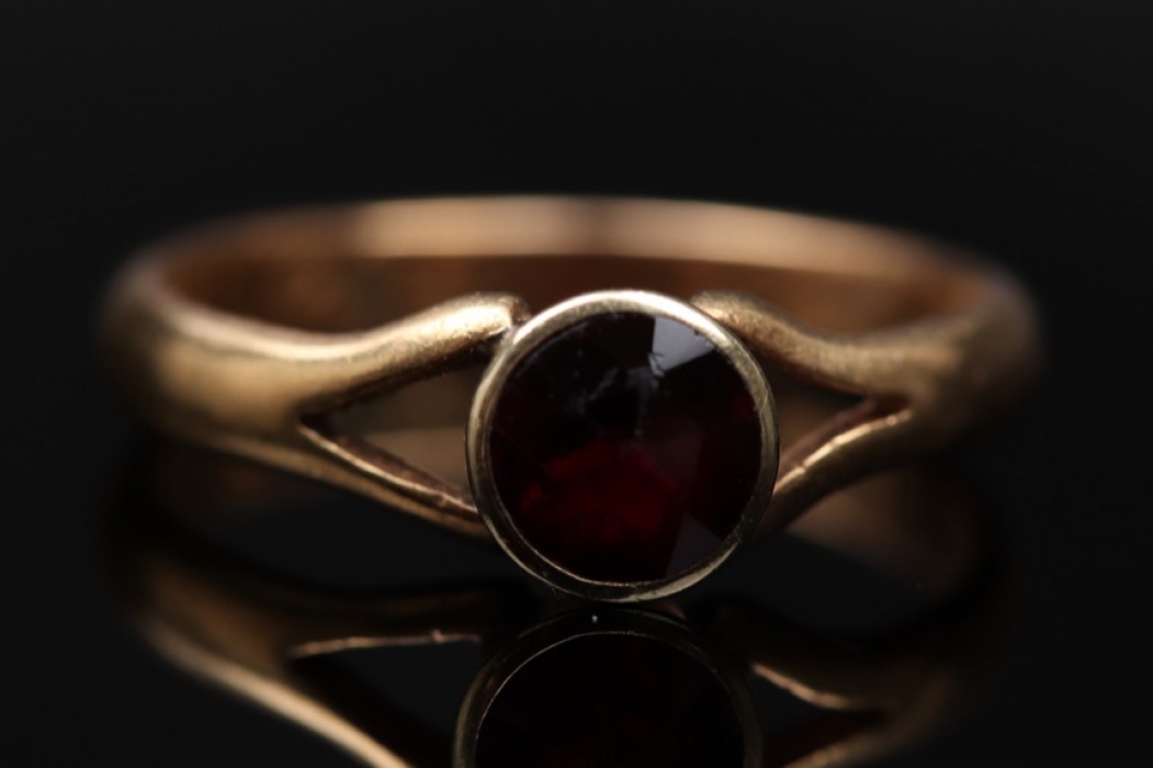 Golden ring with red garnet