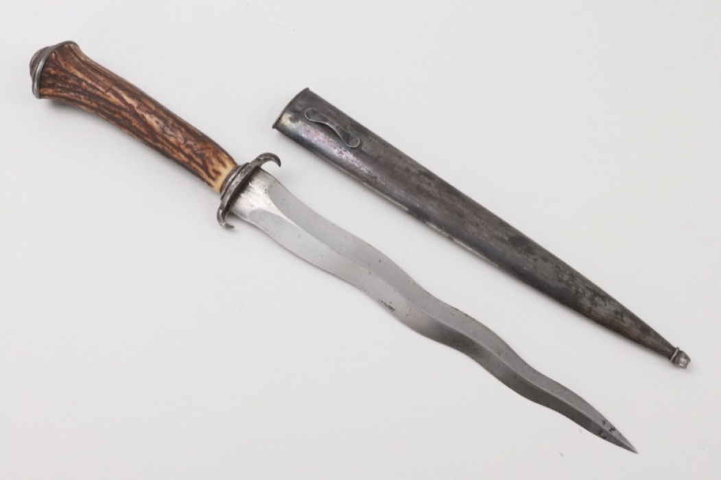 A 19th century dagger with a flame blade