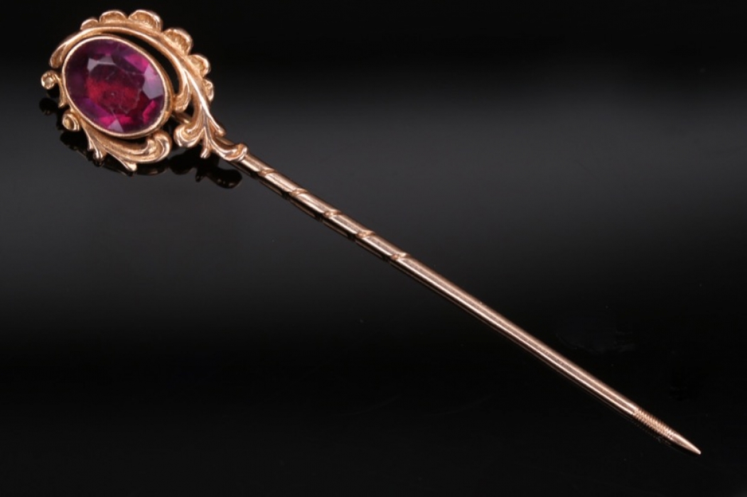 Lapel pin with large dark magenta colored gemstone