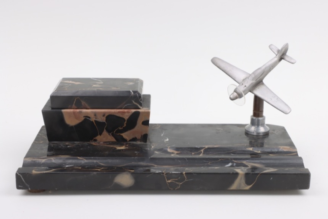 Desk set with inkpot and model plane on black marble base
